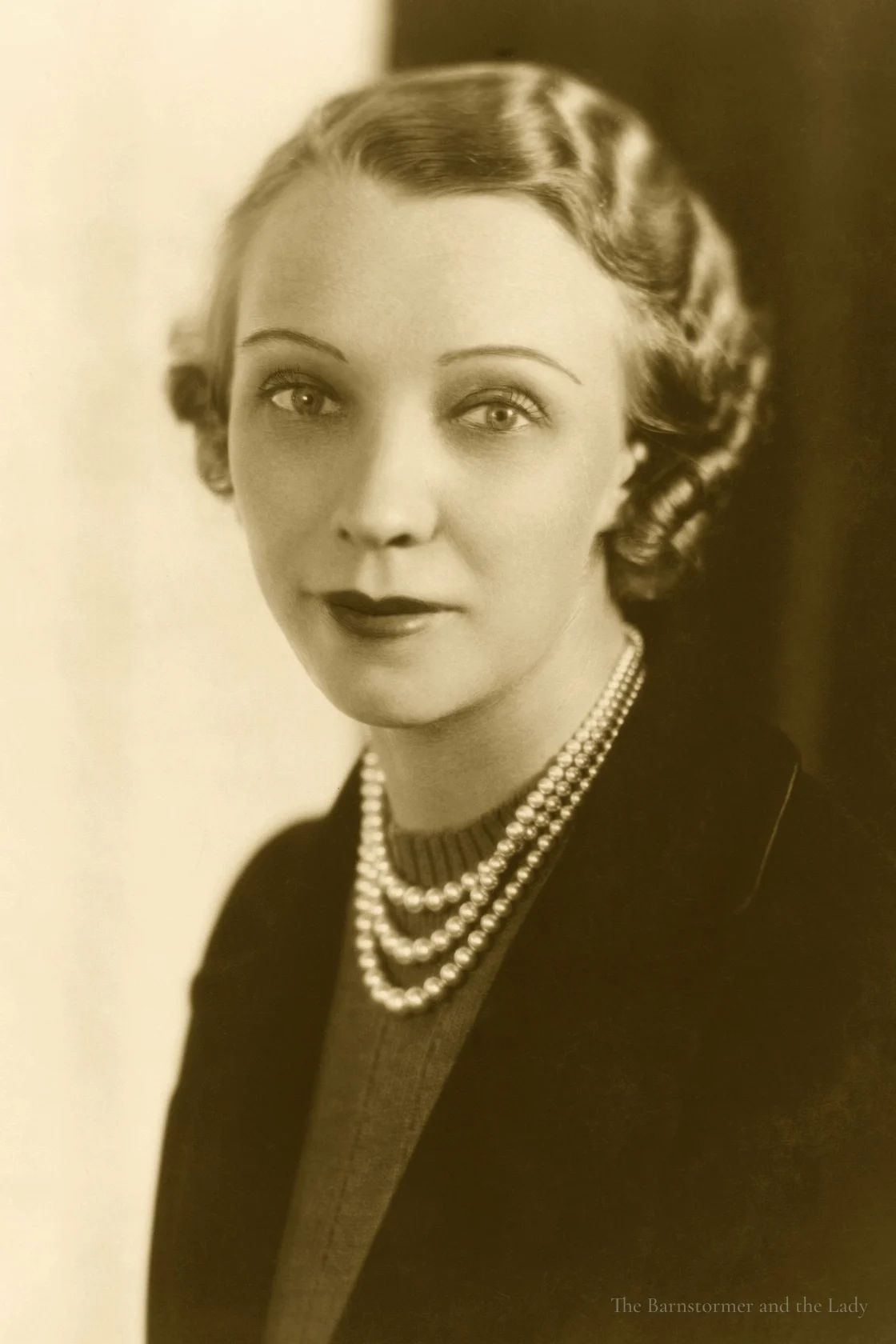 Studio portrait of Olive Ann Beech wearing three strands of pearls
